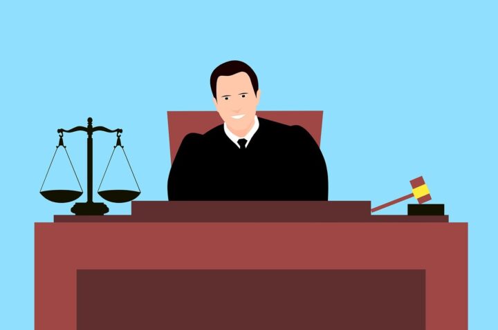 Judge sitting in a court explaining kinds of bail in india|5 Kinds of Bail in India: Categories & Impacts|