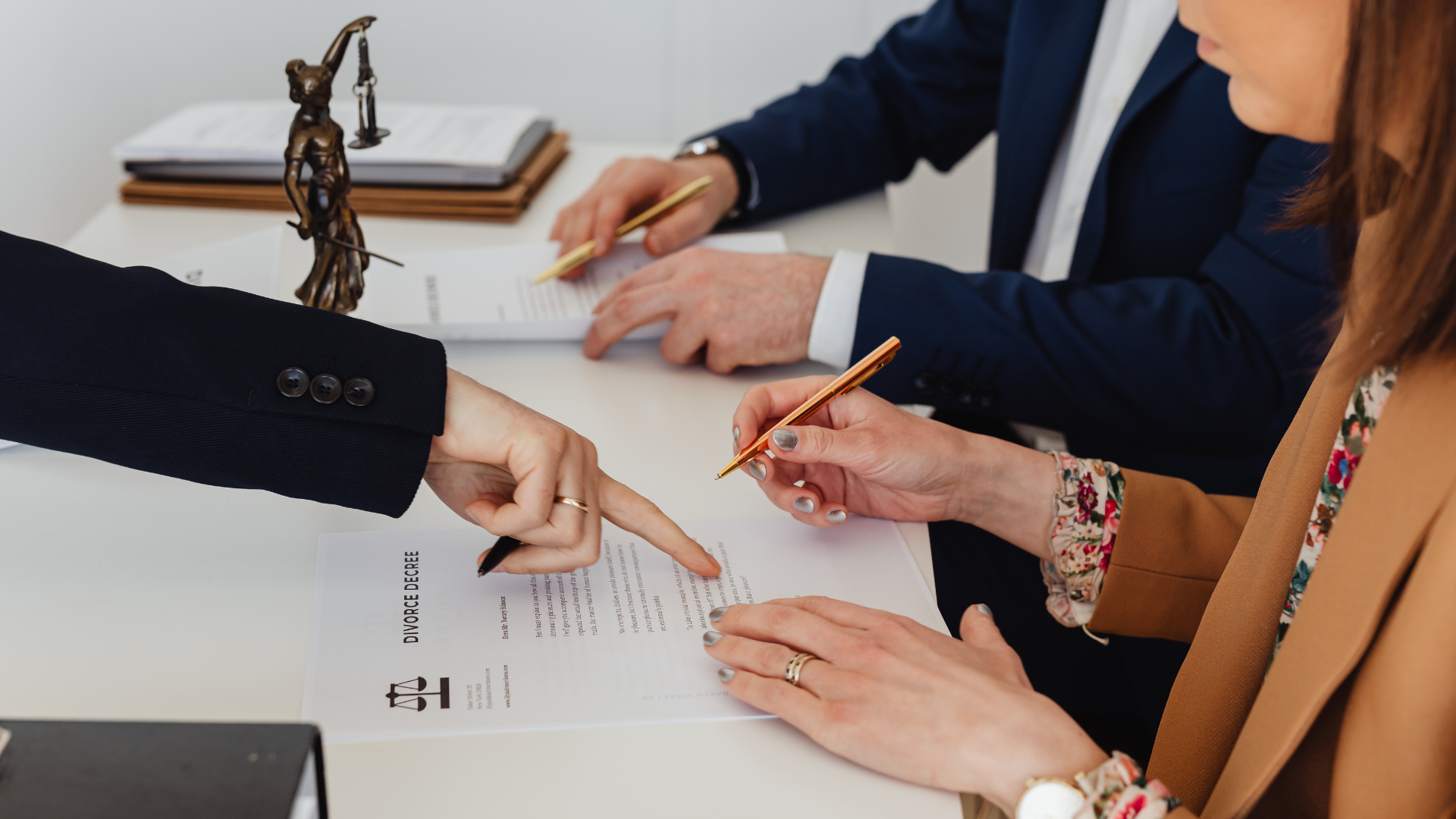 Lawyer reviewing and explaining a divorce decree to a client during a legal consultation in an office.