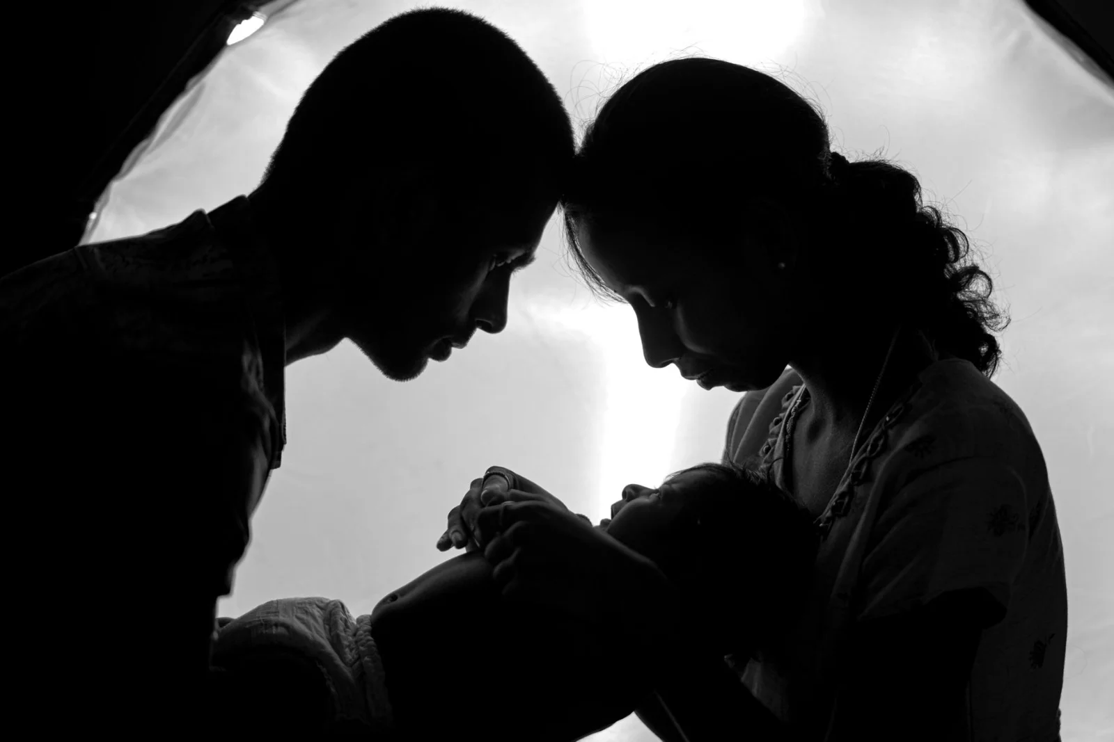 Children Born from Void Marriages Can - A touching silhouette of parents lovingly holding their newborn baby.
