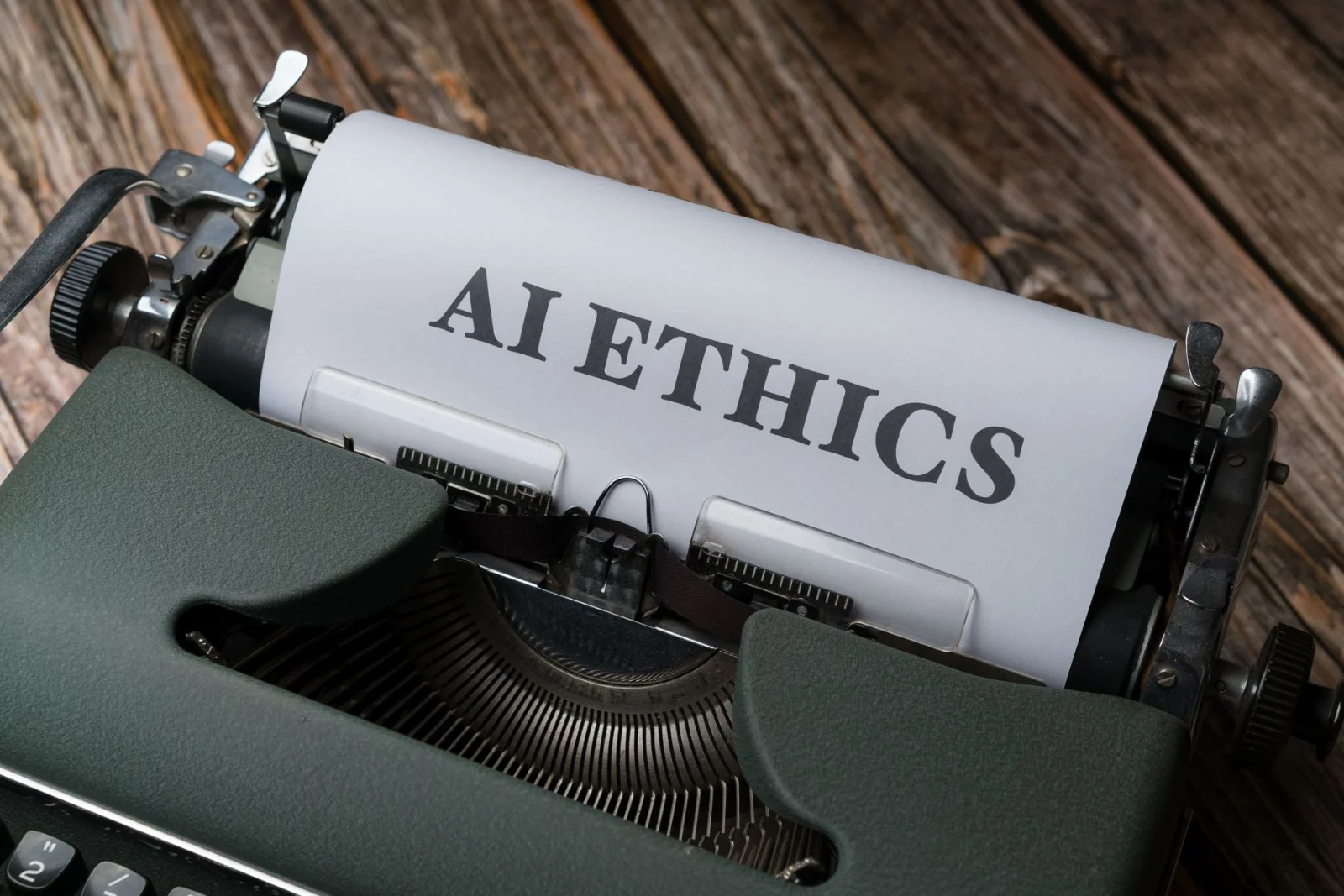 From Human Fault to Algorithmic Accountability: - Retro typewriter with 'AI Ethics' on paper, conveying technology themes.
