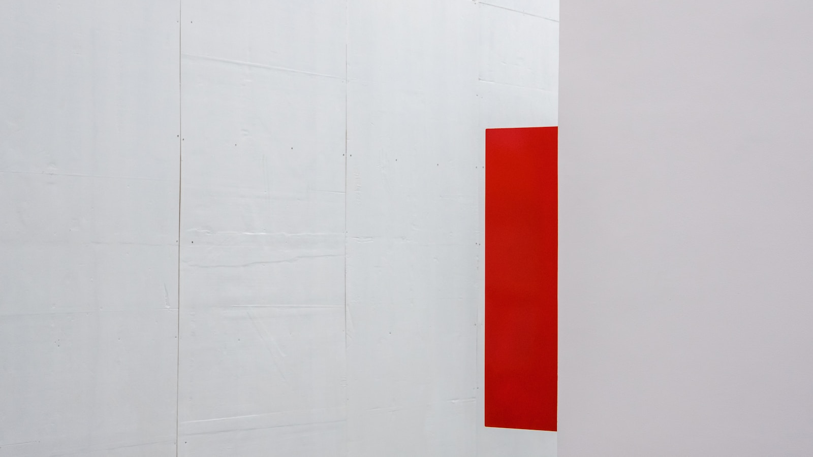 a white wall with a red square on it