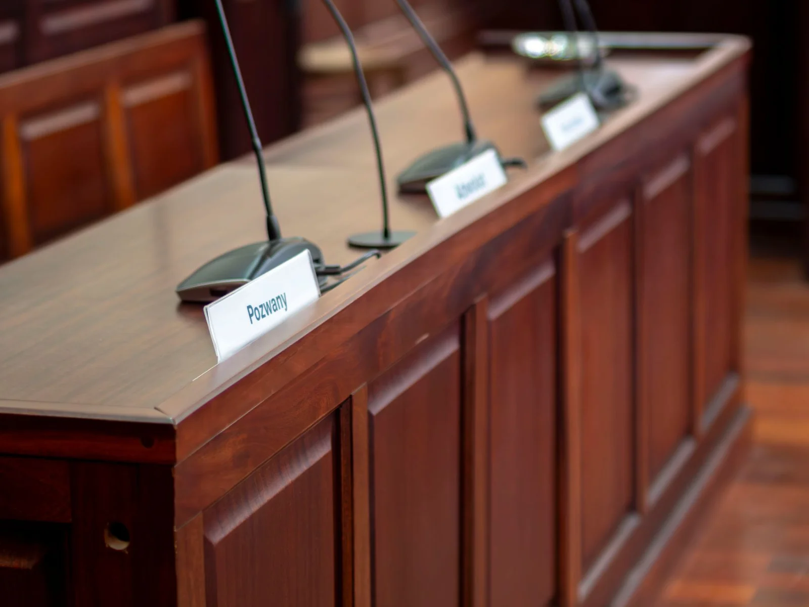 Navigating GSTAT Appeals: Procedure, Pitfalls, and - Empty courtroom desk with microphones and nameplates in a Polish court s