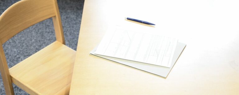 ||man holding incandescent bulb|brown wooden blocks on white surface