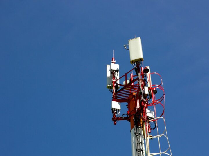 A cell phone tower with a blue sky in the background