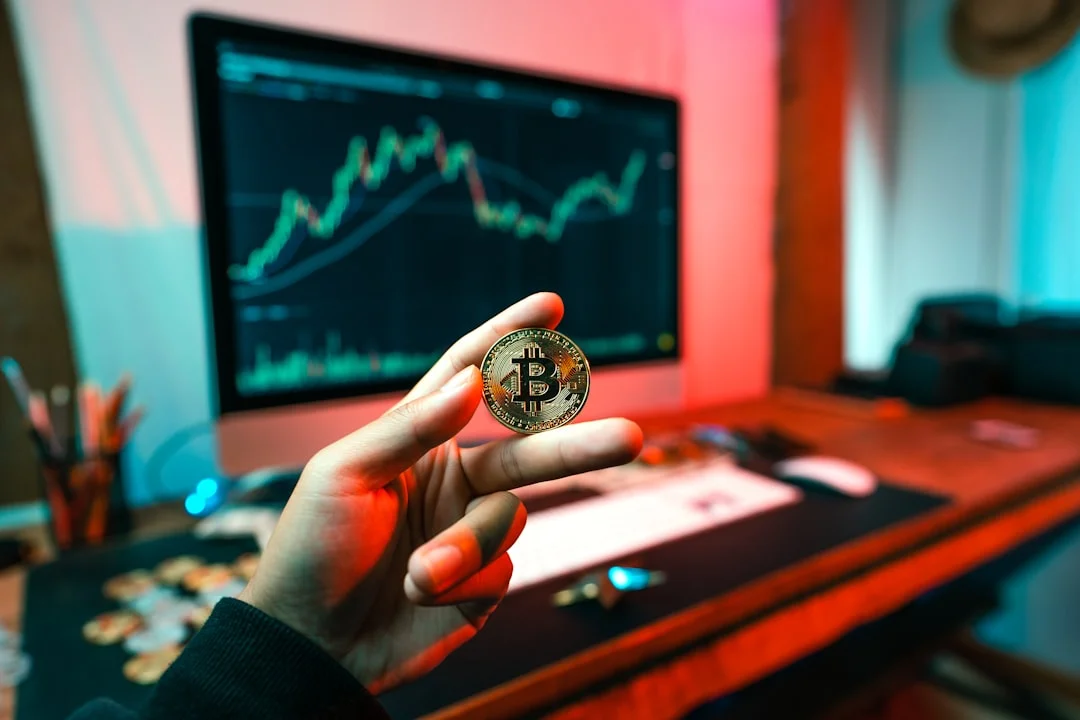 Regulatory Challenges in Crypto Markets: Applying - A person holding a coin in front of a computer