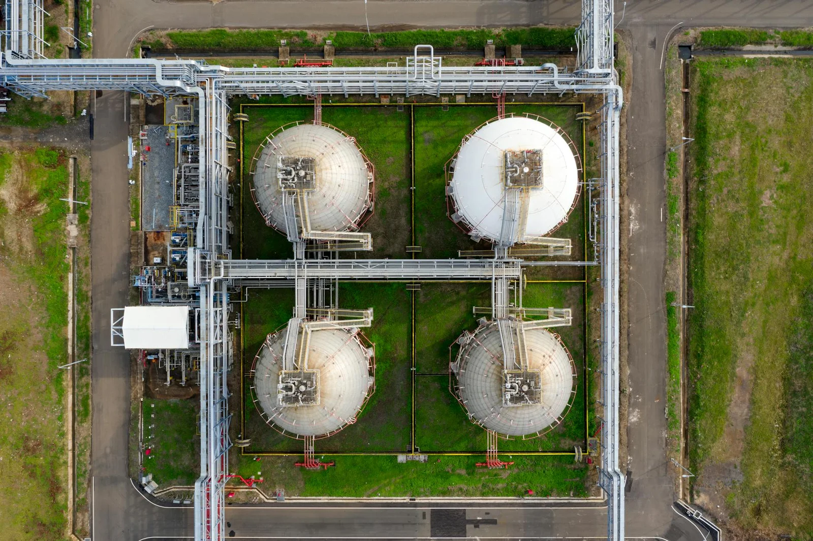 green hydrogen infrastructure india - Green - Aerial view of large industrial storage tanks in Banten, Indonesia, showcasing