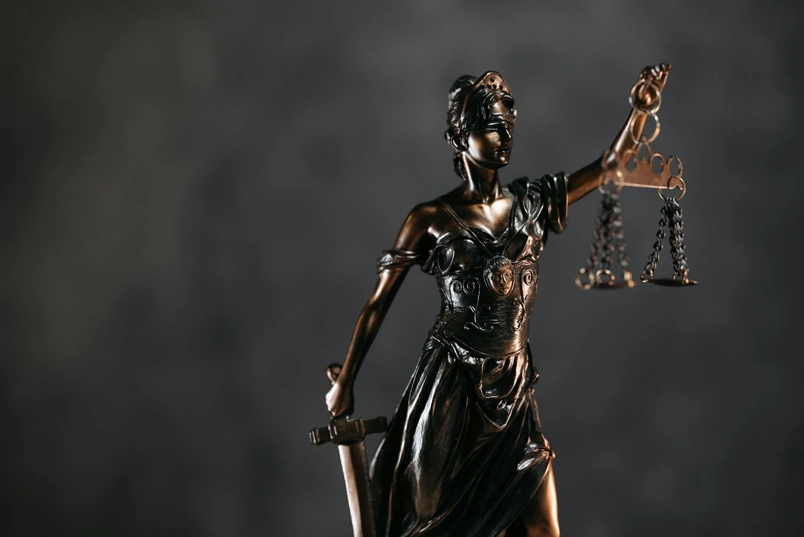 purported awards section 34 arbitration and - Detailed bronze Lady Justice statue with scales and sword against a dark backgr