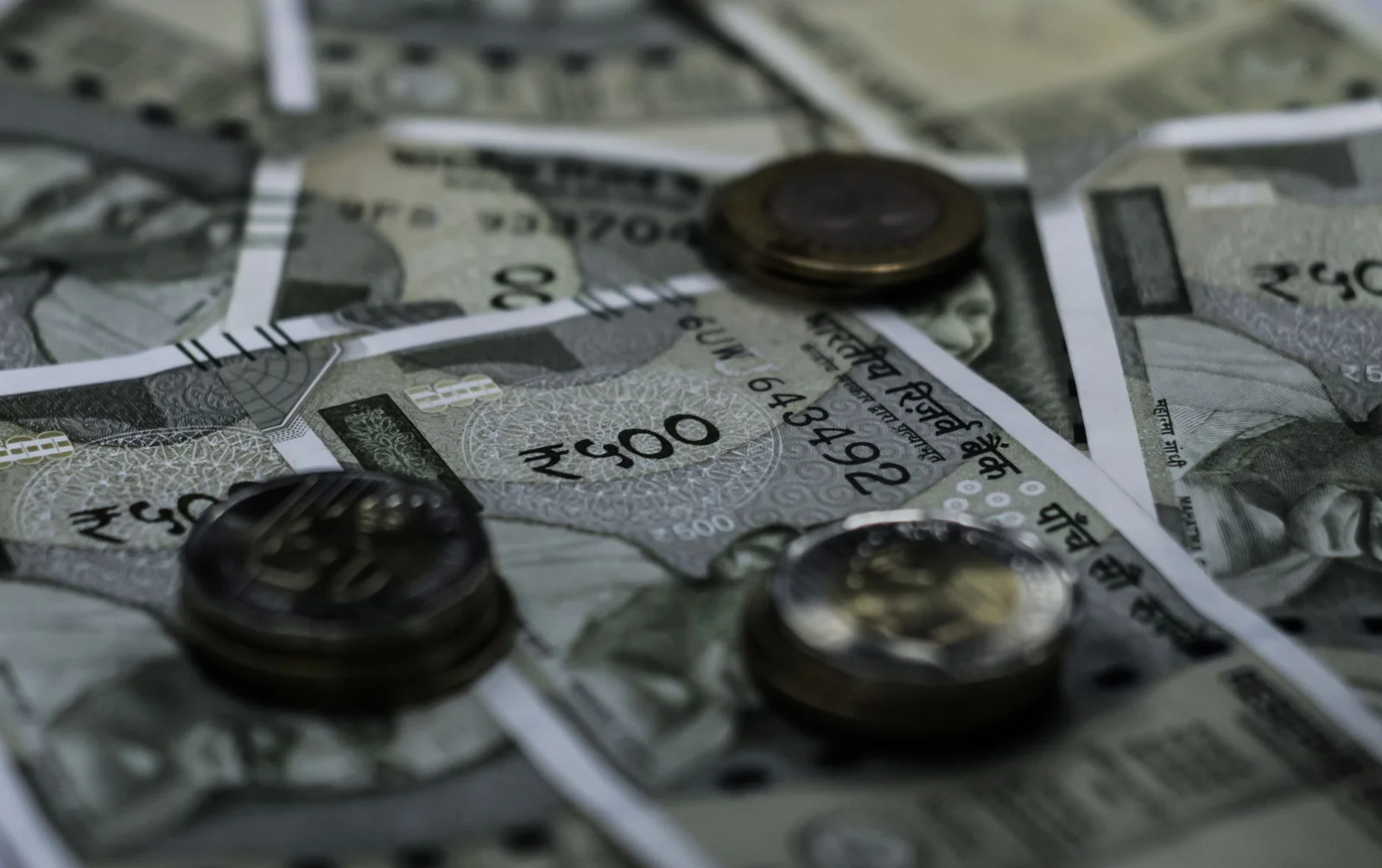 fdi in india - India Opens - Detailed view of Indian currency notes and coins representing wealth and finance.
