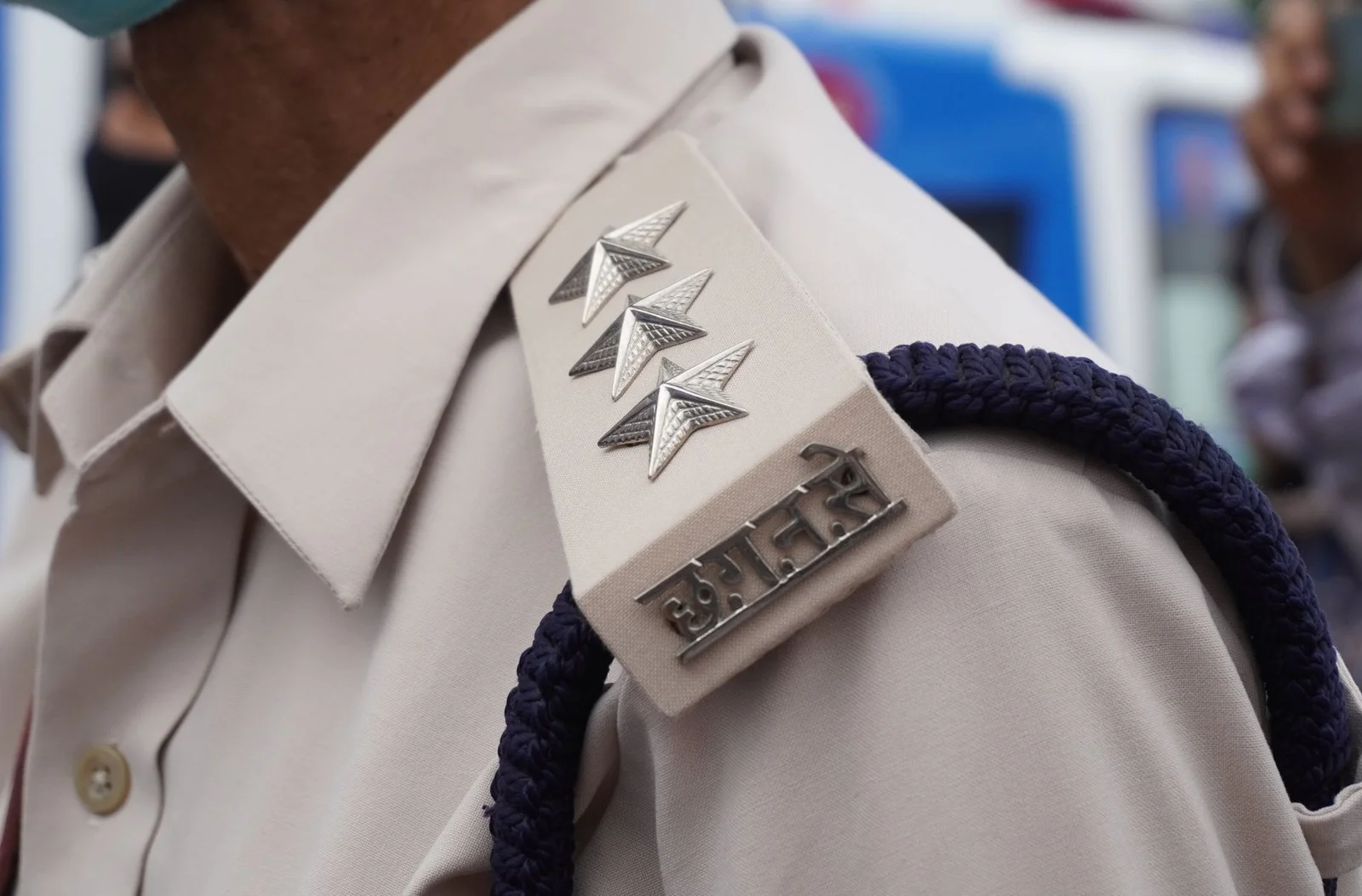 india leniency plus regime competition enforcement - Detailed view of a police officer's shoulder insignia in India.