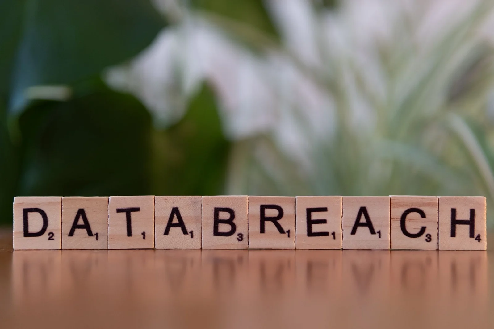 dpdp act director liability - DPDP - Close-up of Scrabble tiles spelling 'data breach' on a blurred background