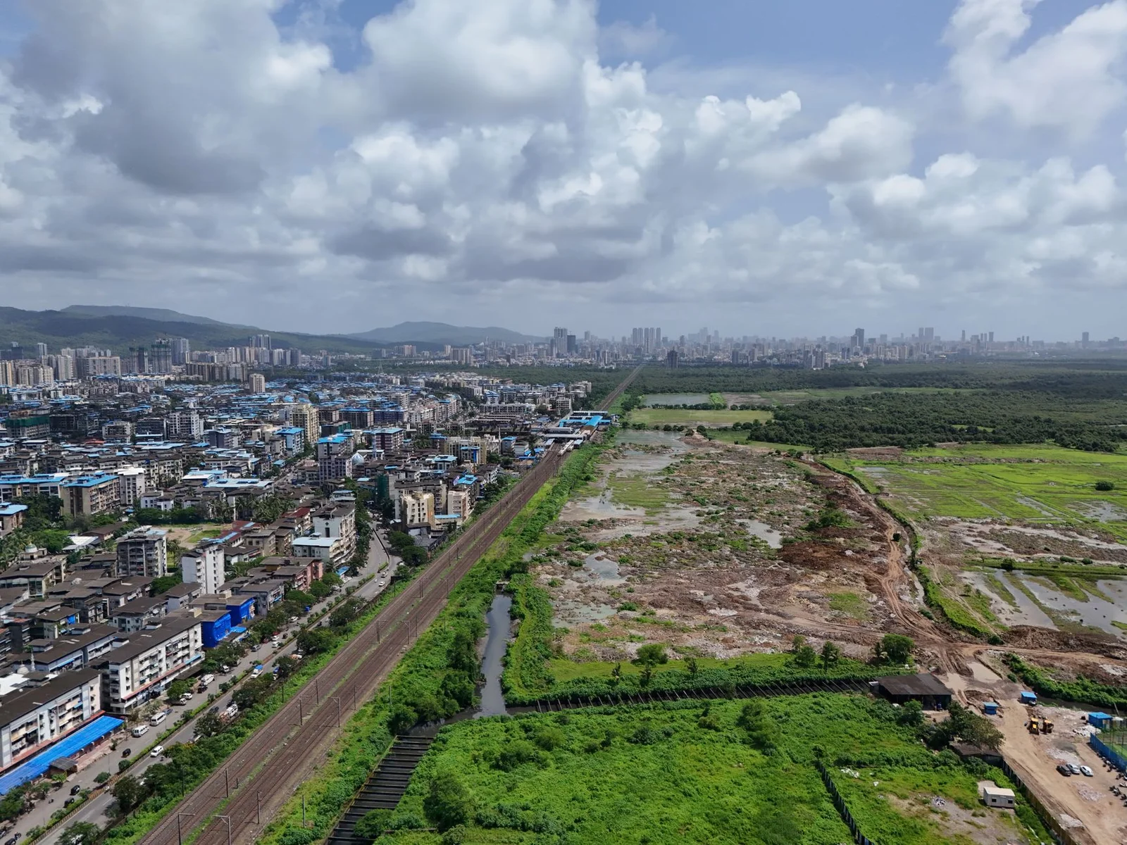 private forest acquisition thane tdr development - Aerial panorama of Mumbai showcasing urban landscape alongside lush greene