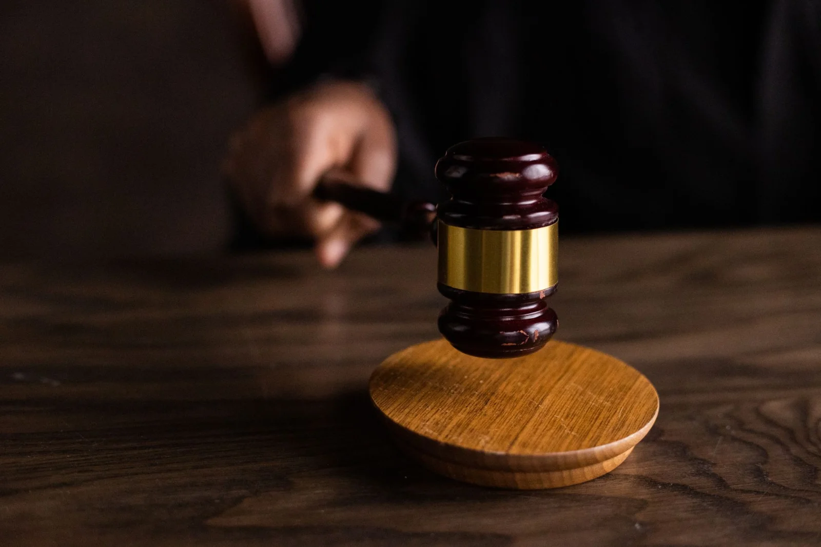 Supreme Court Takes Suo Motu Cognizance - A gavel striking a sound block, symbolizing justice and legal authority in a courtr