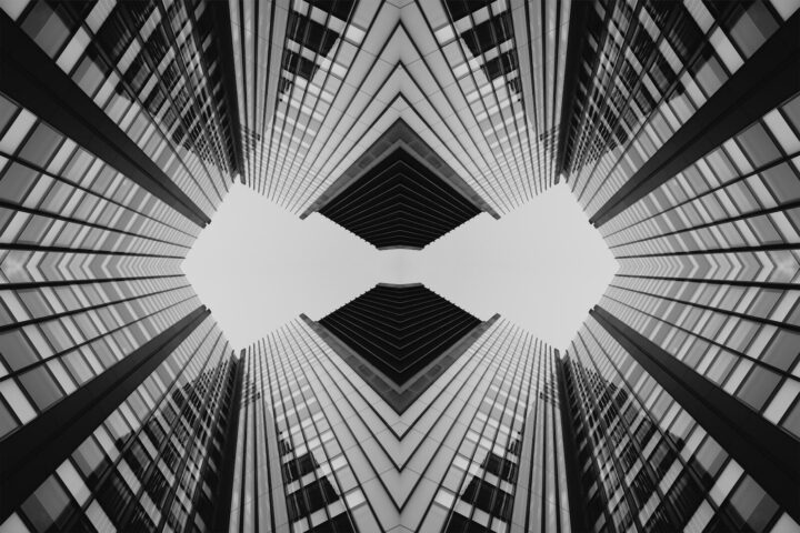 Symmetrical abstract pattern of modern skyscrapers against sky