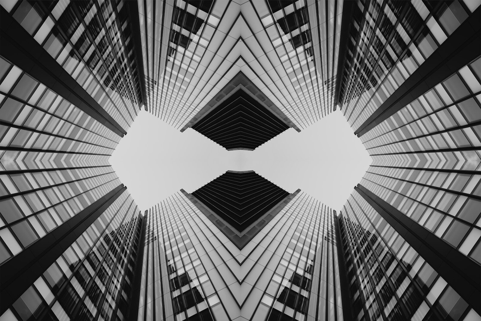 Symmetrical abstract pattern of modern skyscrapers against sky