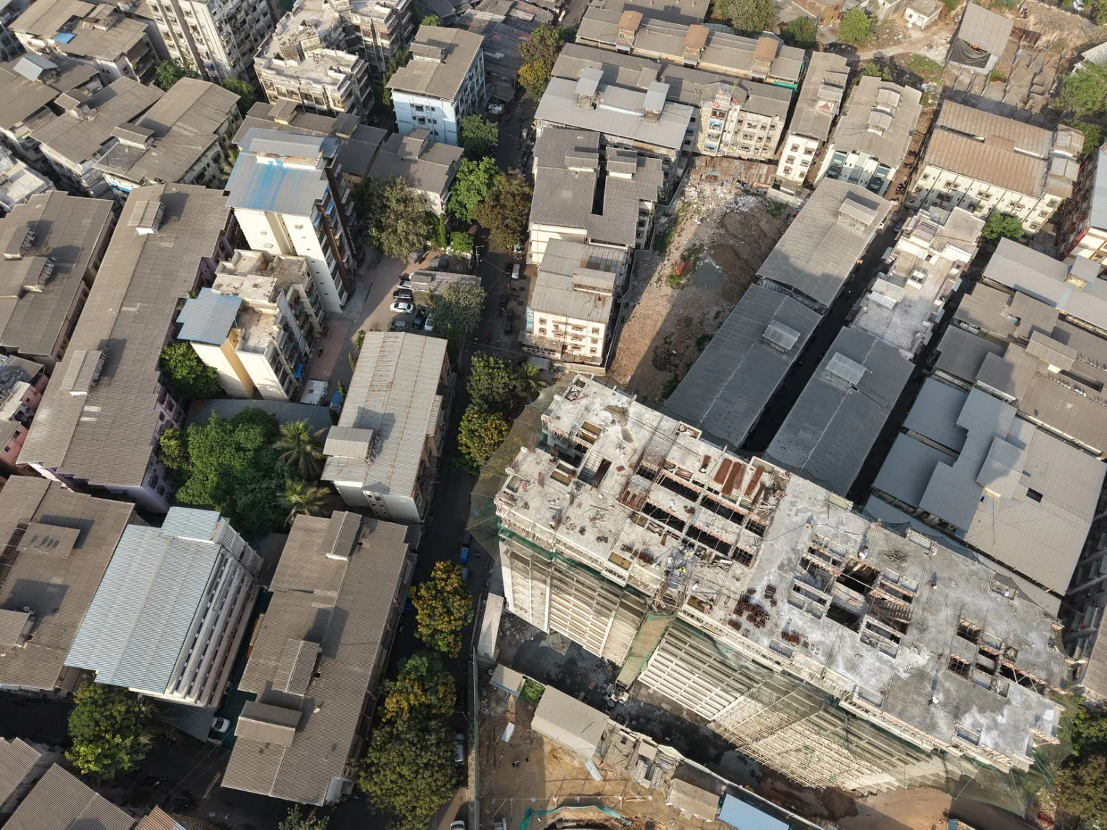 The Maharashtra Co-operative Societies Rules, 2026: - Aerial shot of urban architecture and construction site in Mumbai, Indi