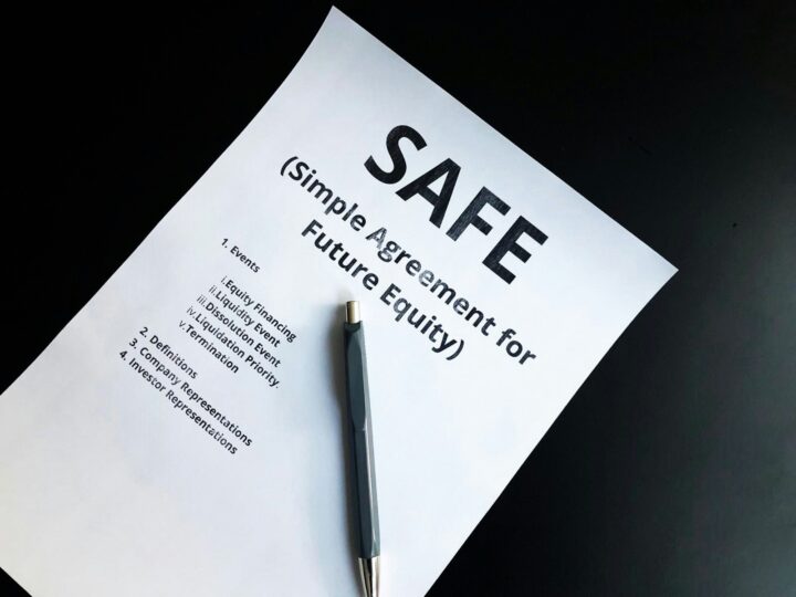 a pen sitting on top of a piece of paper - invest in SAFE
